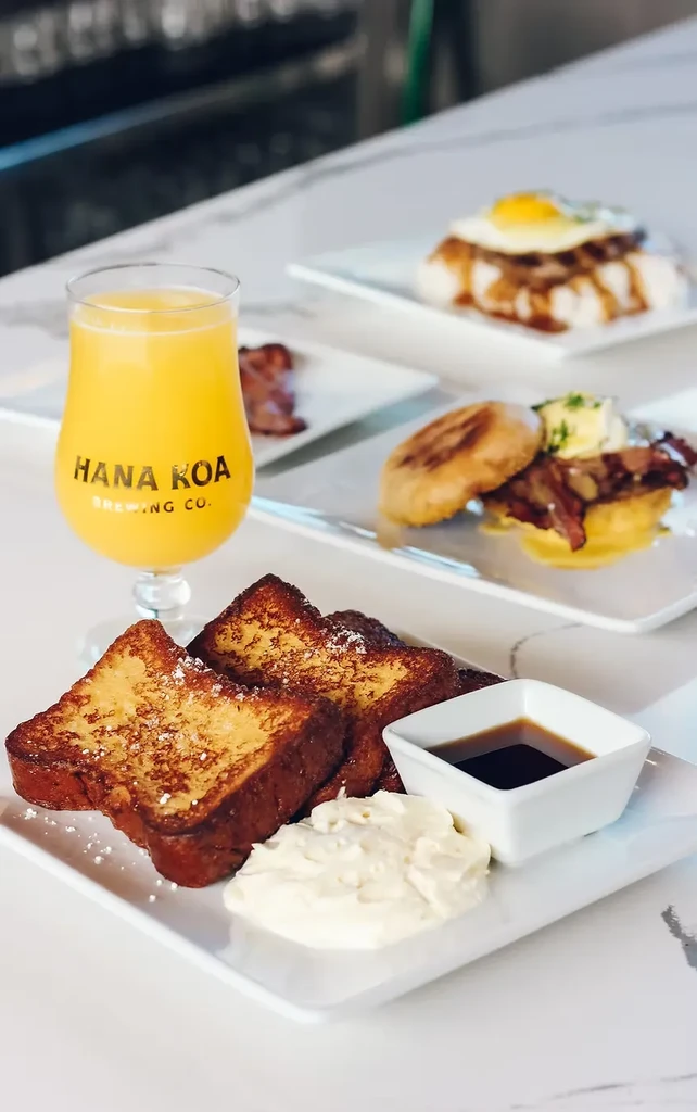 French toast, syrup, and a Hana Koa Brewing Co. beverage.