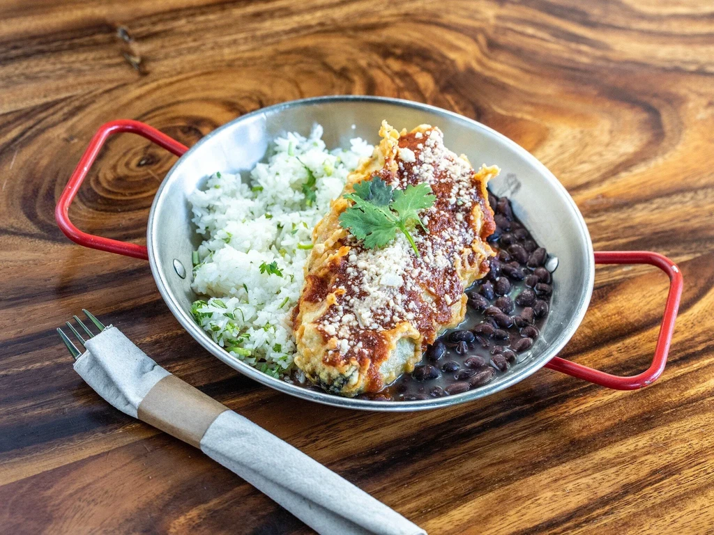 Overhead view: Chili relleno meal with rice and black beans.