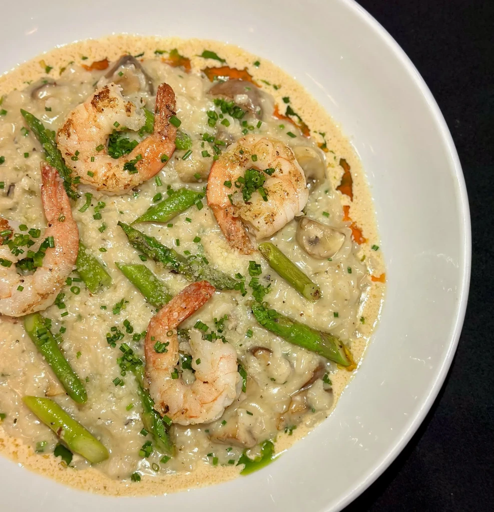 Creamy risotto with shrimp, asparagus, mushrooms, chives, and cheese.