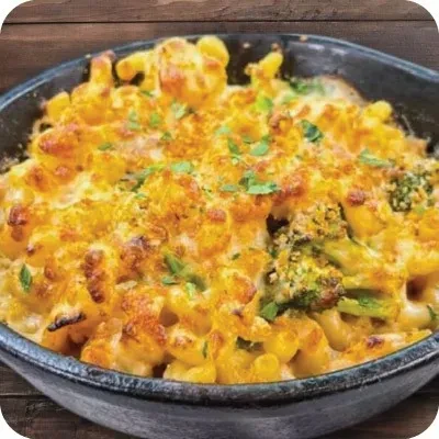 Skillet mac and cheese with crispy topping, broccoli, and fresh herbs.