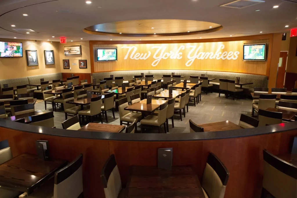 An empty New York Yankees-themed restaurant with many tables and chairs.