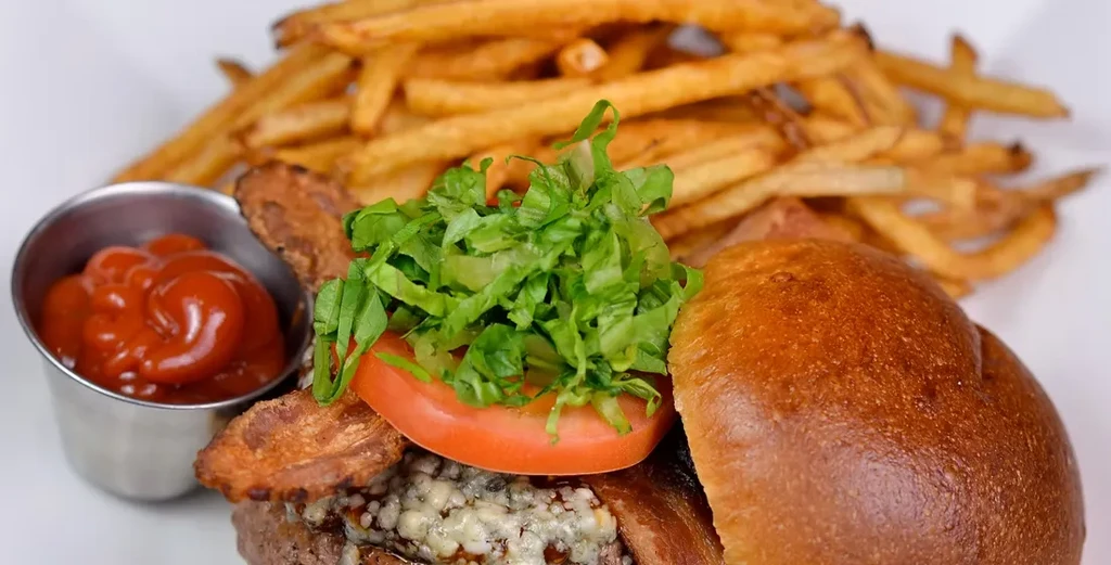 Close-up of a burger, fries, and a side of ketchup.