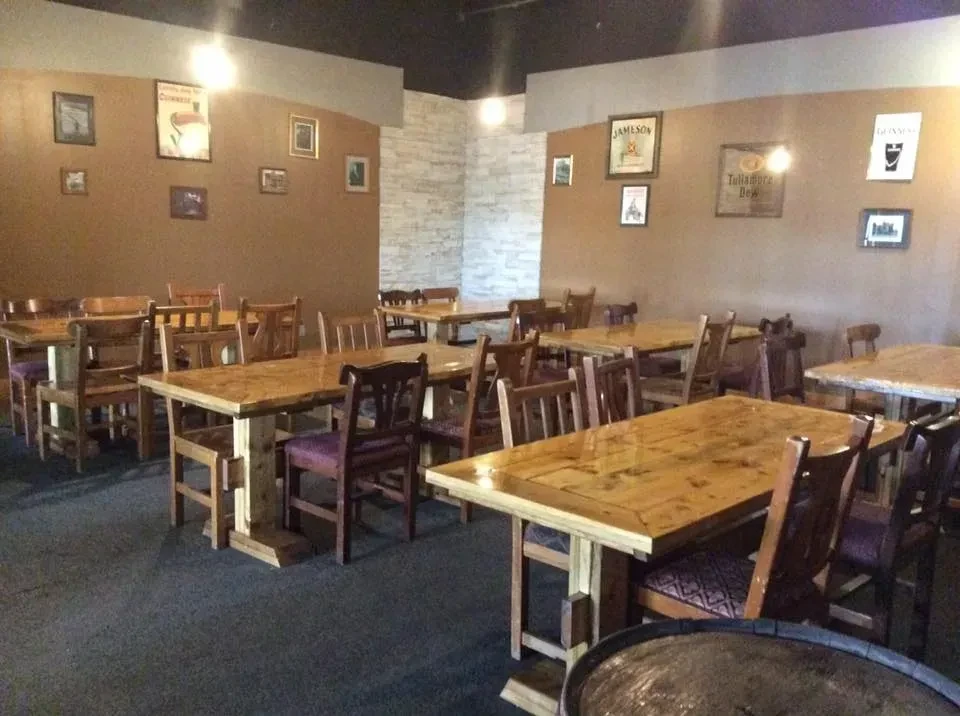 Empty Irish pub dining room with wooden tables and chairs.