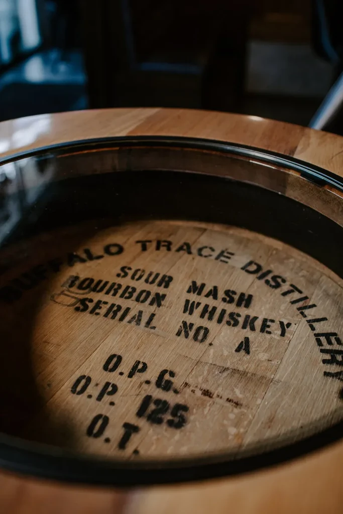Close-up of a wooden Buffalo Trace whiskey barrel head with stenciled text.