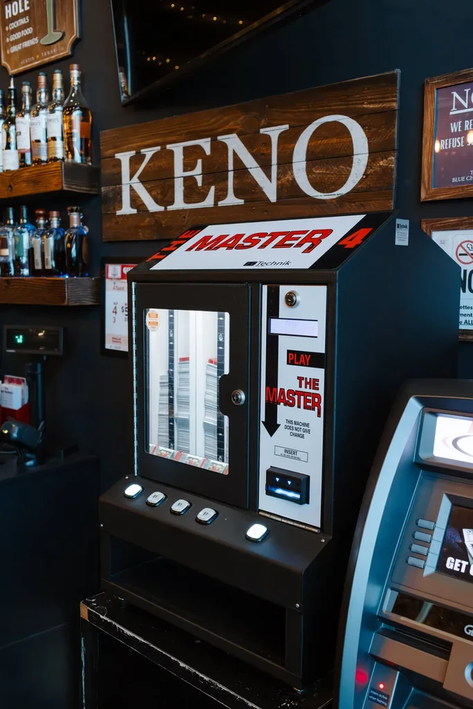 Keno gaming machine, PLAY THE MASTER, with liquor bottles.