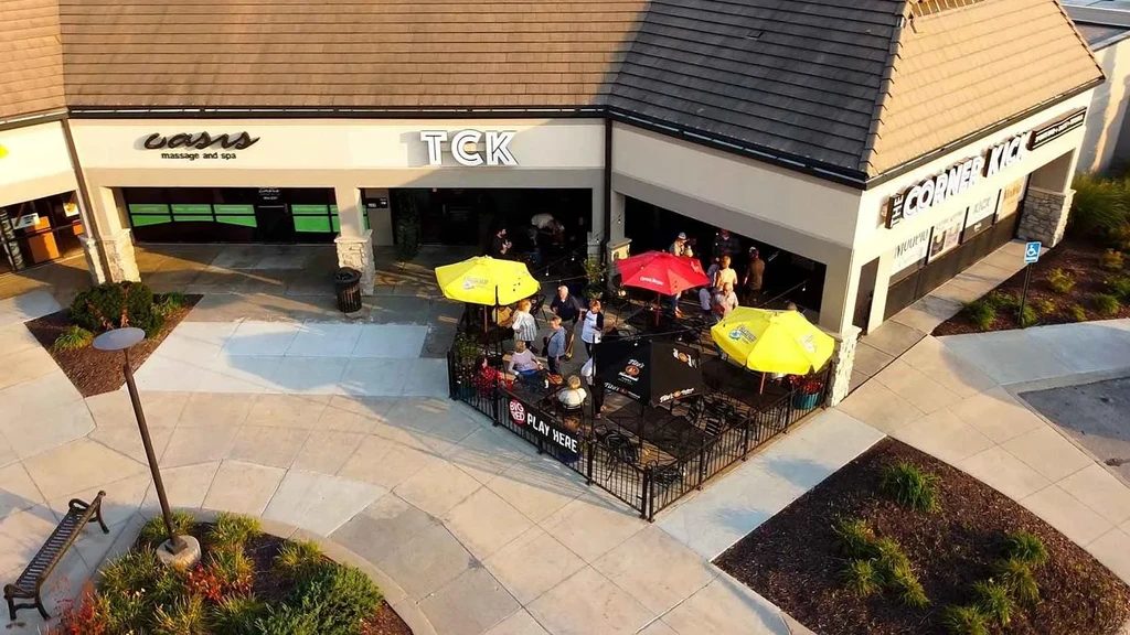 Aerial view of an outdoor dining patio with people at golden hour.