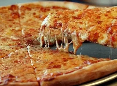 A lifted slice of cheese pizza shows abundant, stringy melted cheese.