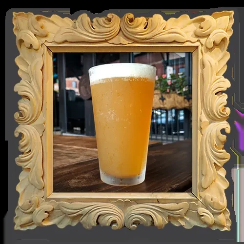 Ornate wooden frame around a hazy amber drink with foam, outdoors.