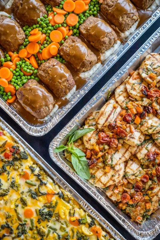 Meatloaf, grilled chicken, vegetable casserole in three catering foil pans.