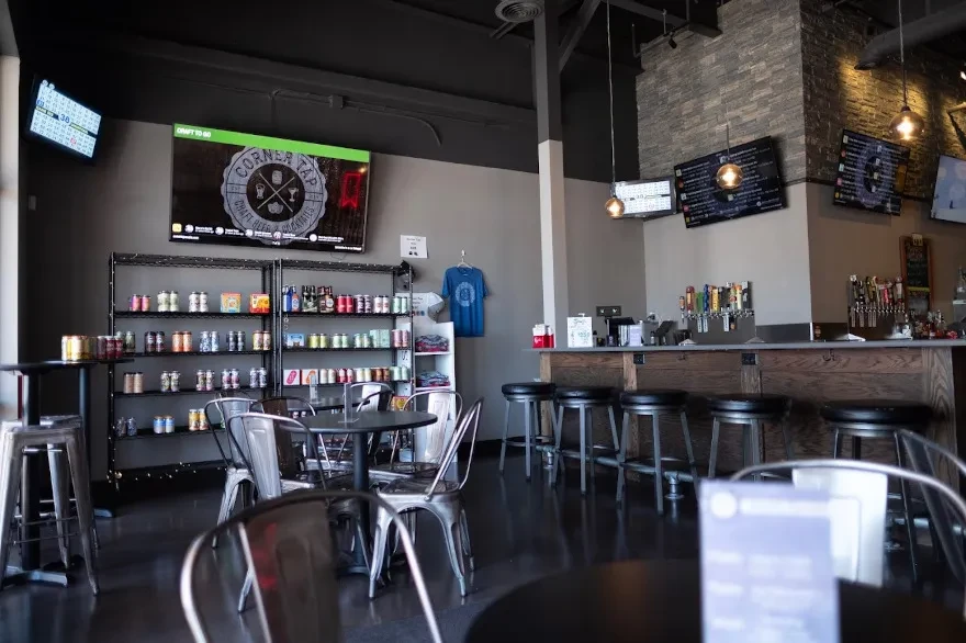 Modern industrial-chic craft beer and cocktail bar with 'CORNER TAP' logo.