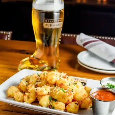 Fried food, cheese, sauces, boot-shaped beer at Millstone Pub.