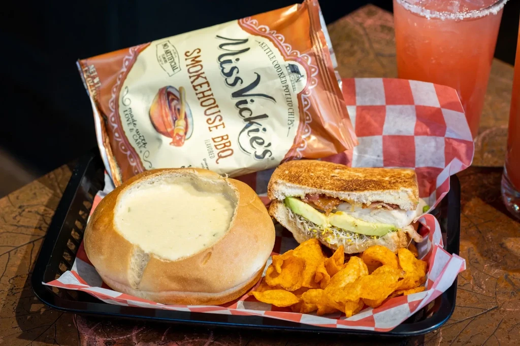 Soup in bread bowl, toasted sandwich, Miss Vickie's chips, and drinks.