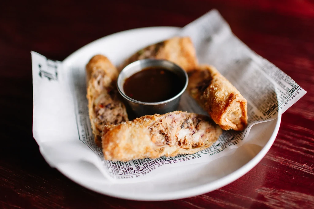 Crispy fried spring rolls with savory filling and dipping sauce.