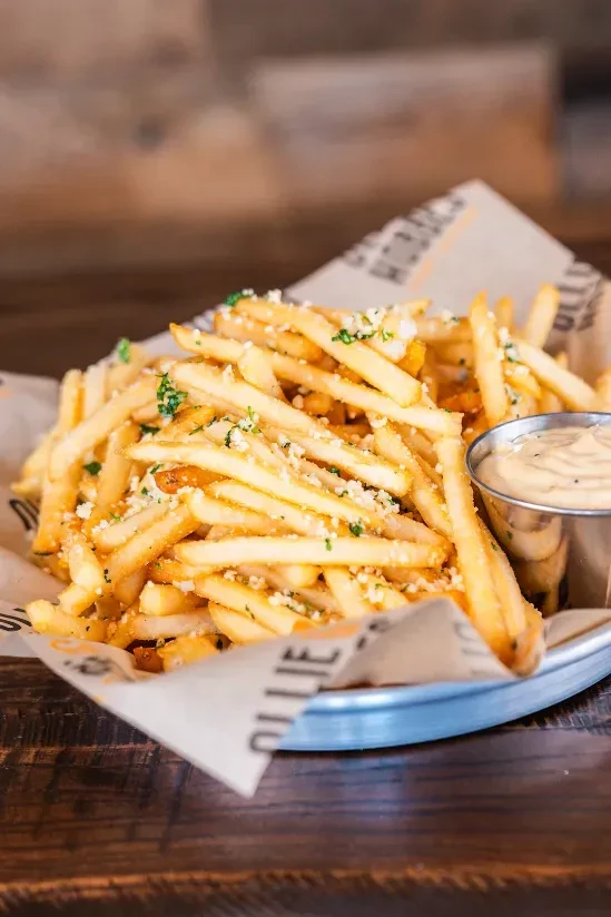 French fries with Parmesan, green herbs, and creamy dipping sauce.