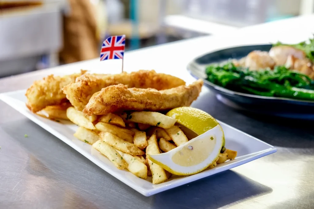 British fish and chips plate with lemon wedge and Union Jack pick.