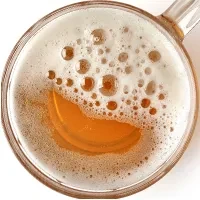 Close-up overhead view of a beer with a frothy white head.