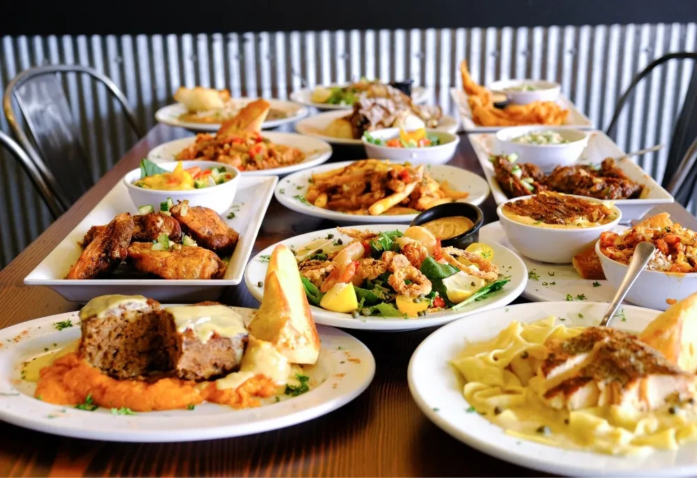 Vibrant restaurant table filled with a diverse selection of food dishes.