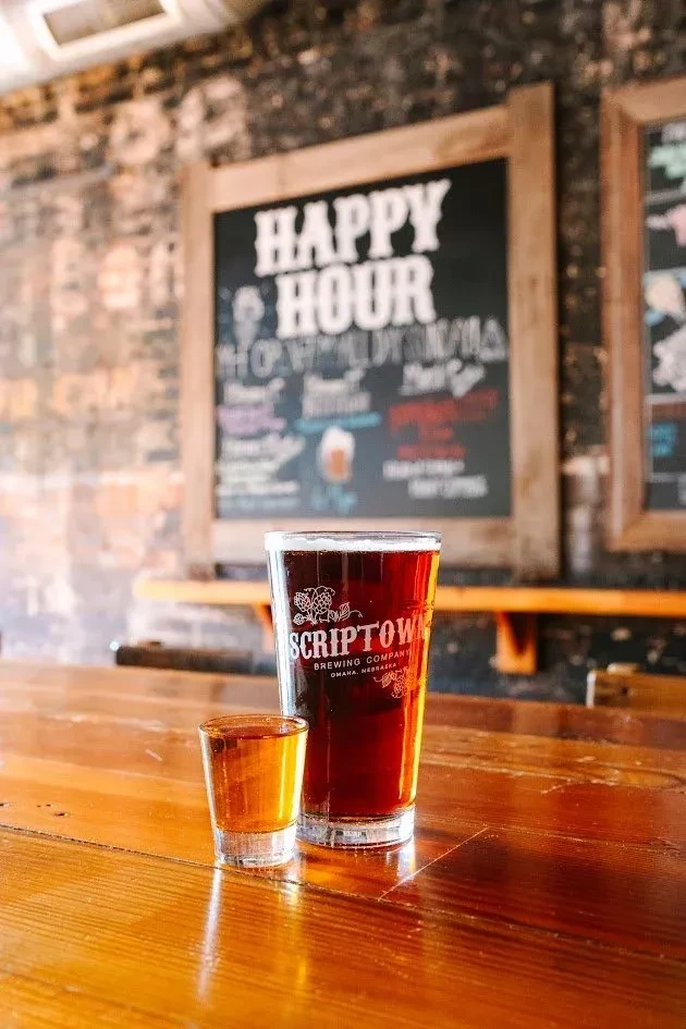Amber beverages in Scriptown Brewing Company pint and shot glasses.