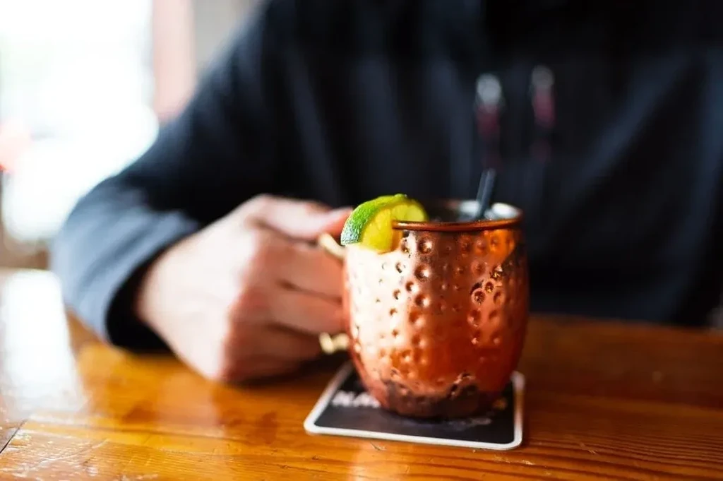 Moscow Mule in hammered copper mug with lime and straw.