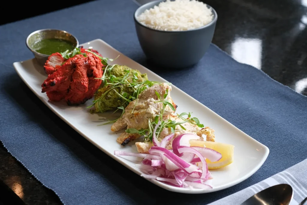 Well-plated Indian chicken platter with red, green, and white chicken.