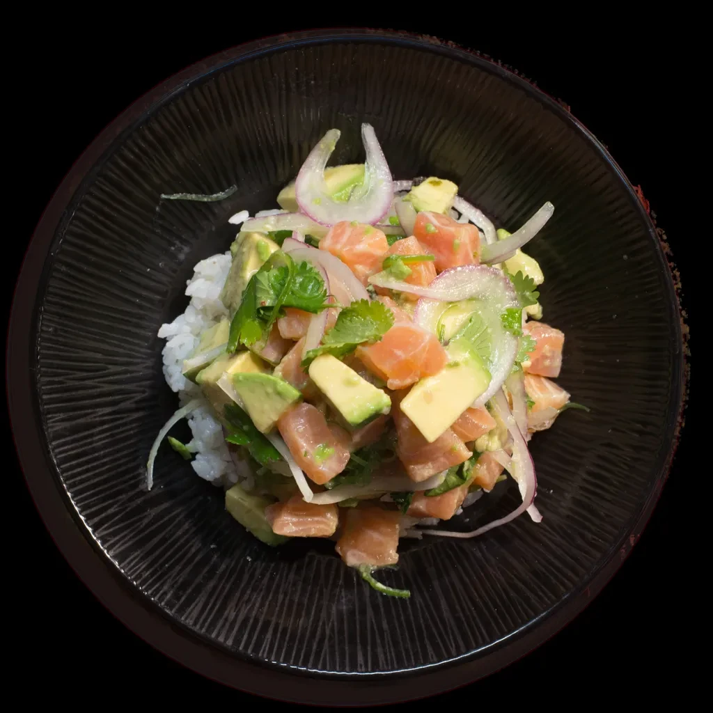 Colorful salmon poke bowl with rice, avocado, red onions, and cilantro.