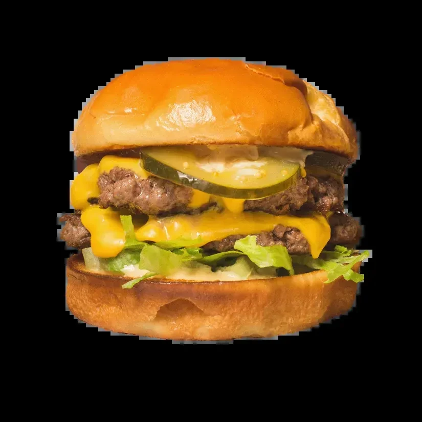 Front-facing double cheeseburger with melted cheese, lettuce, pickles, and sauce.