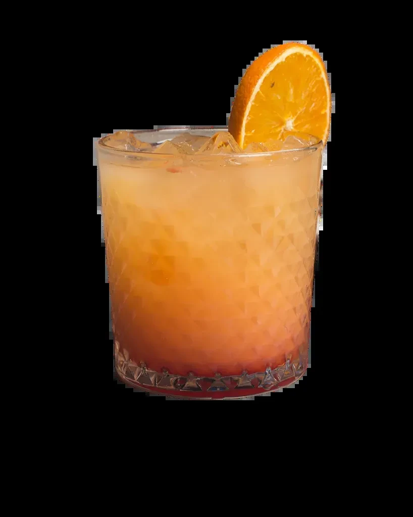Gradient orange cocktail with ice and orange slice in a faceted glass.