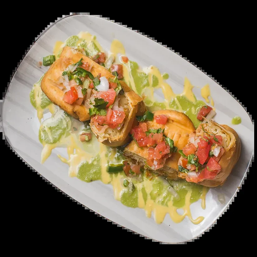Golden-brown fried dough topped with pico de gallo and two sauces.