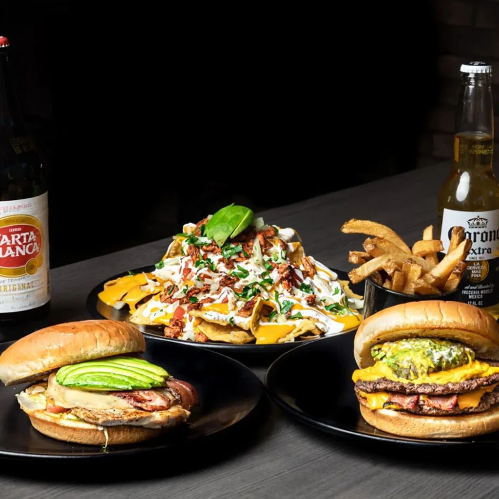 Loaded nachos, two burgers, fries, Carta Blanca and Corona beers.