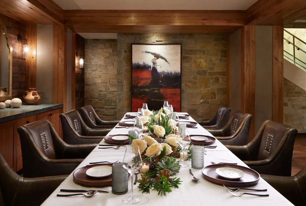 Rustic private dining room with a long, elegantly set table.