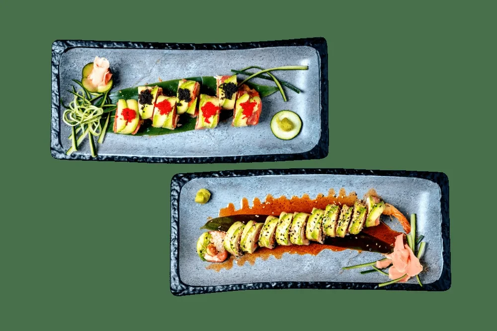 Two sushi rolls: one topped with caviar, one avocado-wrapped with shrimp.