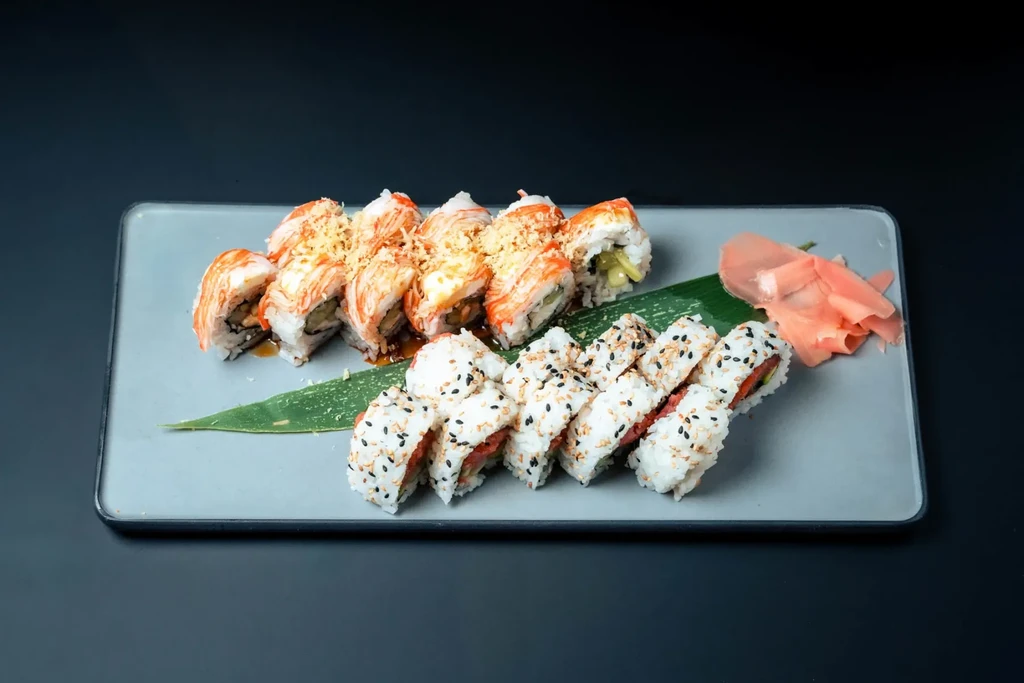 Platter of sushi rolls: seafood-topped, sesame-crusted, with ginger.