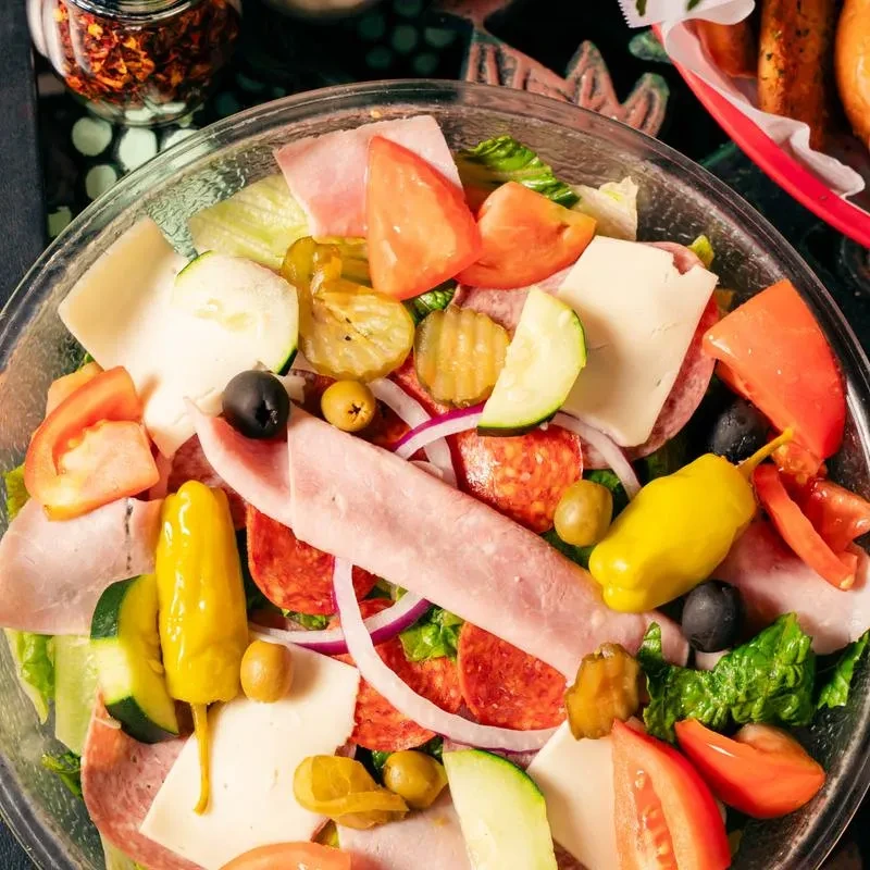 Colorful Italian deli salad packed with meats, cheese, and vegetables.