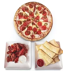 Overhead shot of pizza, chicken wings, and breadsticks with dipping sauces.