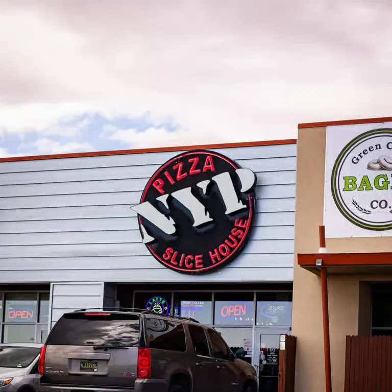 Pizza N.Y.P. Slice House exterior, prominent sign, and parked SUV.
