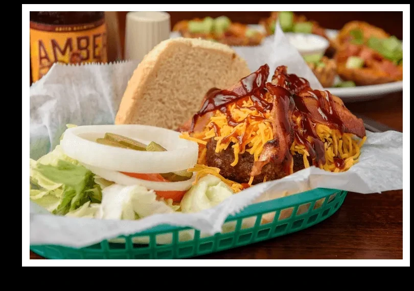 BBQ burger patty with cheddar, bacon, and salad in a basket.