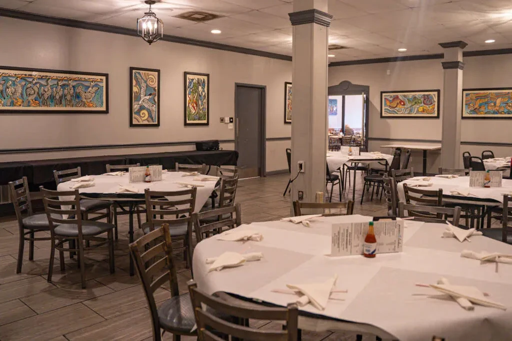 Neat restaurant dining area with set tables and colorful animal art.