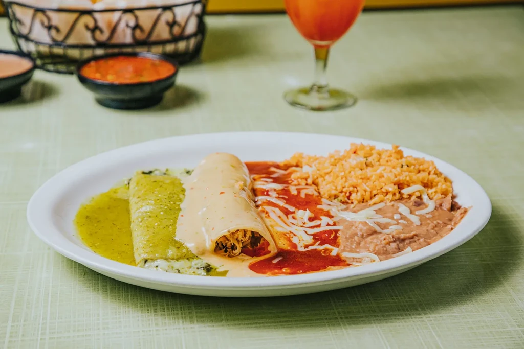 Mexican combination platter: three enchiladas, rice, and refried beans.