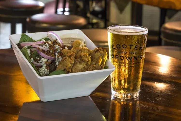 Fried oyster salad, blue cheese, and a Cooter Brown's pint of beer.