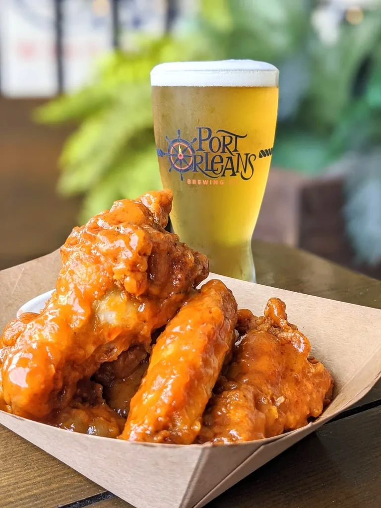 Buffalo-style chicken wings and a frosty Port Orleans beer.
