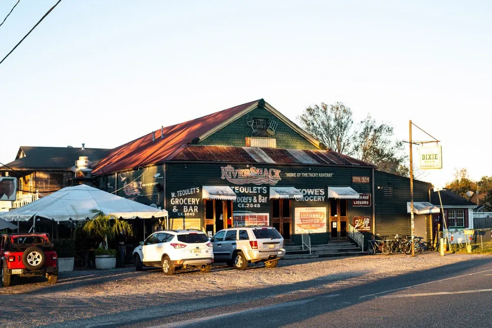 W. Teoulet's rustic green grocery and bar, outdoor tent.