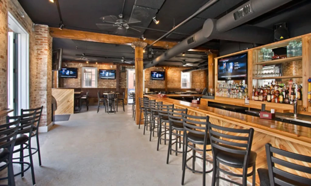 Empty modern industrial bar and restaurant with wood and brick decor.