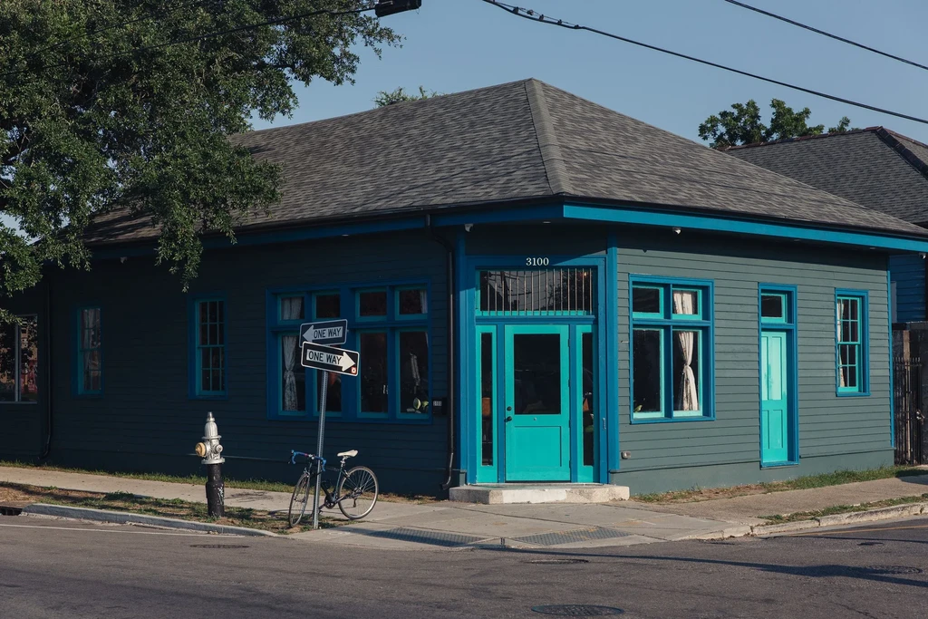 Building 3100, blue-gray siding, teal trim, dark gray roof.