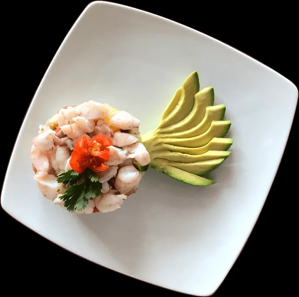Ceviche dish on white plate, fanned avocado, tomato flower, herb.