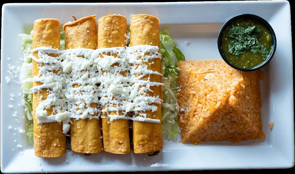 Mexican rolled tacos with cream, cheese, rice, and green salsa.