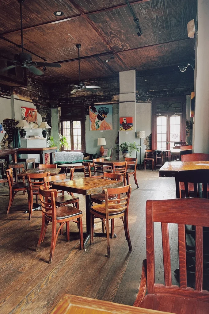 Empty rustic cafe interior featuring distressed walls and modern art.