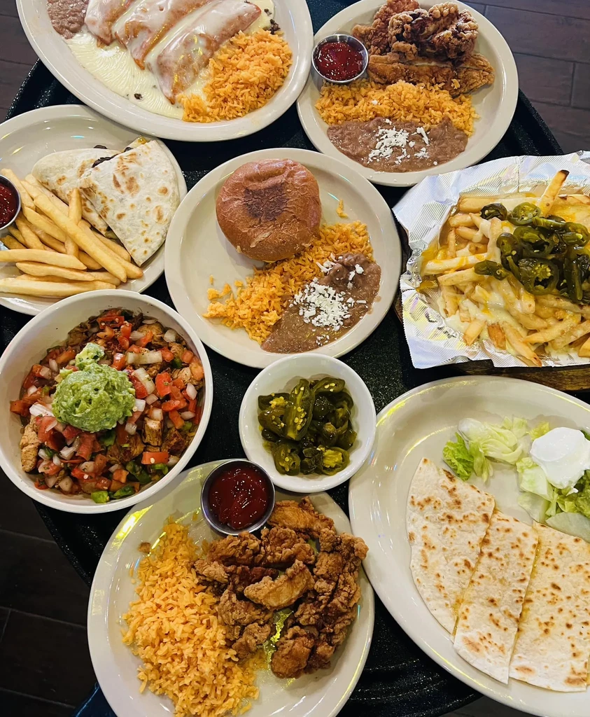 Overhead view of numerous Mexican and Tex-Mex dishes.