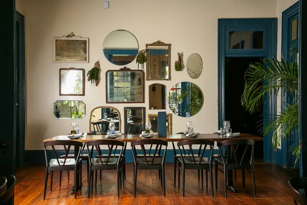 Set dining table in a stylish restaurant with eclectic mirrored wall.