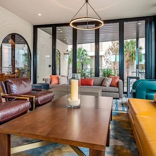 Modern lounge with diverse seating facing an outdoor patio.