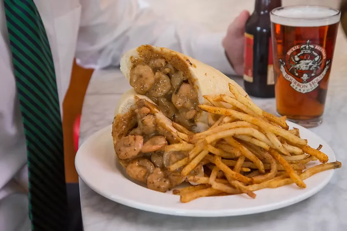 BBQ shrimp po-boy served with seasoned fries and amber beer